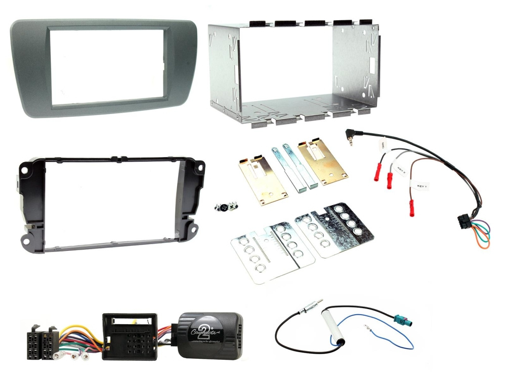 Installationskit för dubbel-DIN stereo, inklusive ram och diverse komponenter.