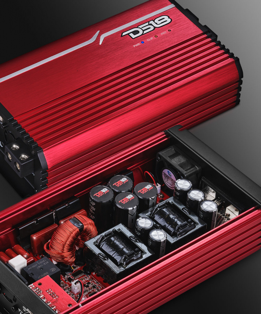 En röd förstärkare med elektronik och komponenter synliga inuti.