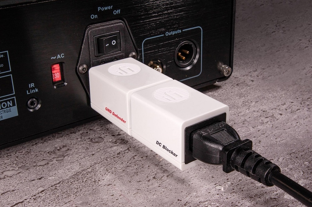 Produkt med två vita enheter som ansluts till en ljudutrustning.