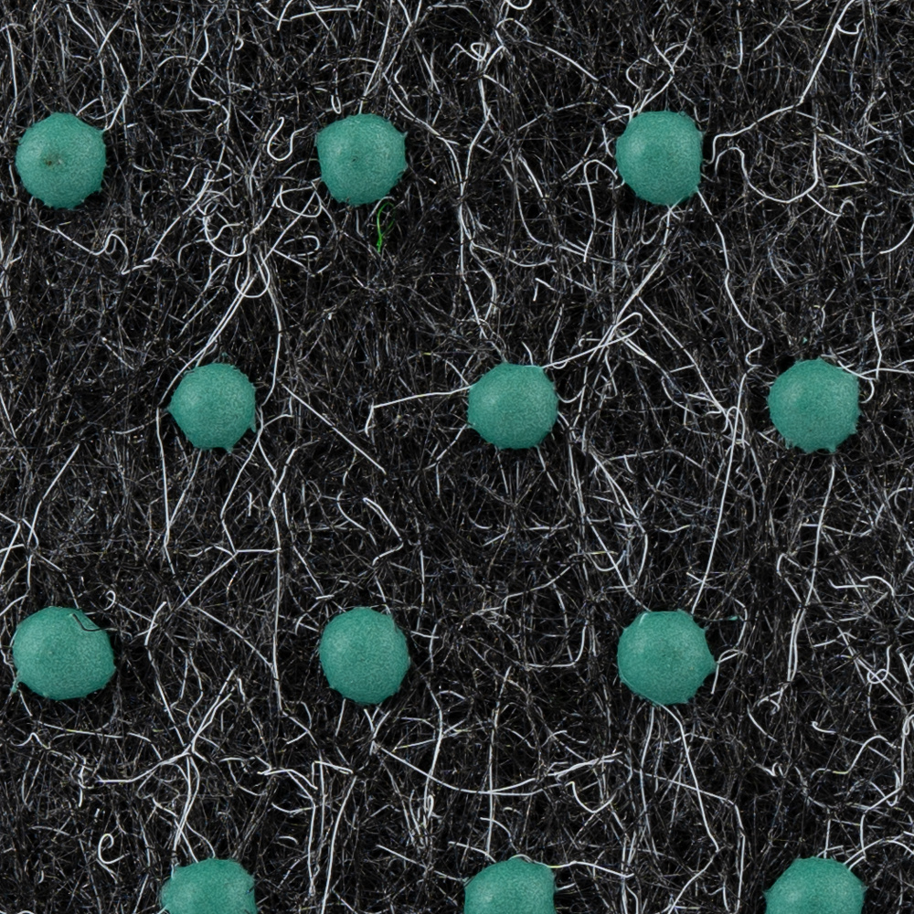 Textur av konstgräsmatta med gröna prickar på en svart bakgrund.