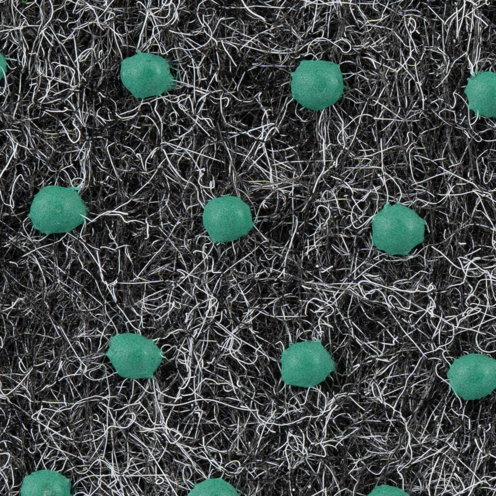 Konstgräsmatta med svart bas och gröna prickar.