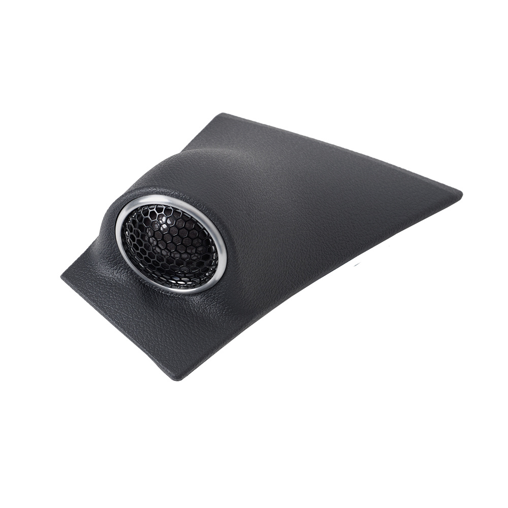 En svart högtalare med metallgaller, formad för att passa in i bilinteriör.