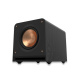 Klipsch RP-1000SW med Yamaha YH-E700B på köpet En svart subwoofer med kopparfärgad element.
