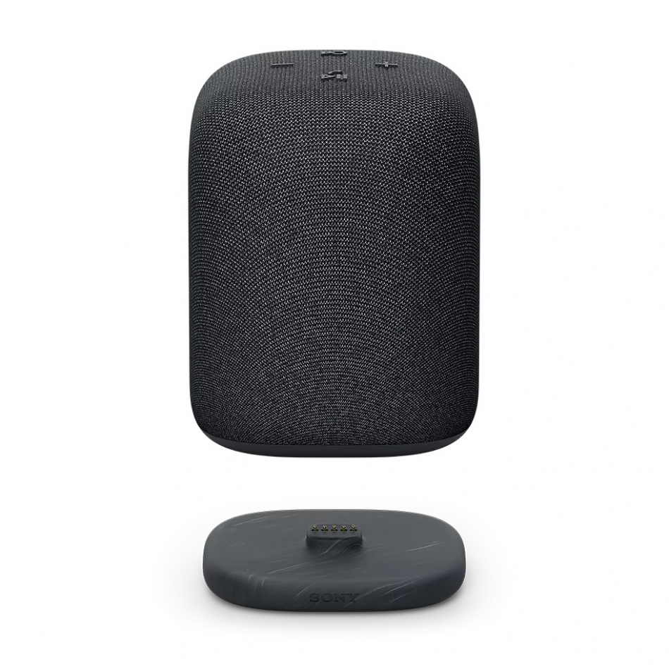 Trådlös bärbar högtalare i svart, rundad design med kontroller och laddstation.